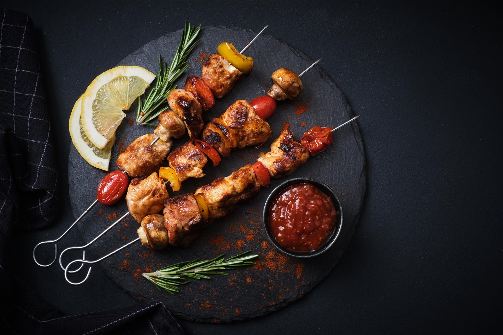 Charcoal-grilled chicken skewers with lemon and fresh herbs
